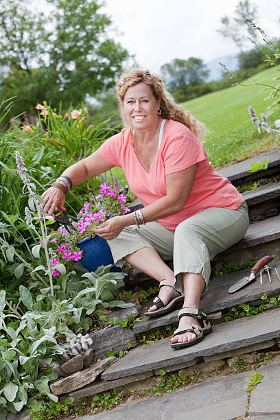 giardiniere - women large build gardening outdoors foto e immagini stock