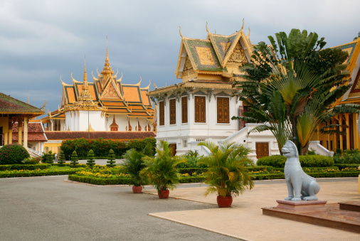 Phnom Penh Palace: Napoleon III Pavilion and Hor Samrith Phimean (the aEBronze Palace'). A dark stormy sky provides a dramatic backdrop to the beauty of the Palace.