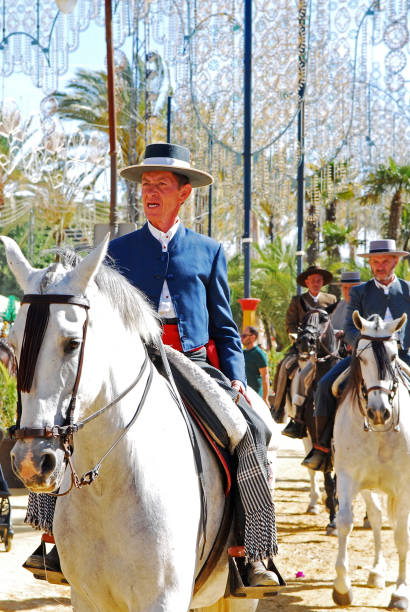 Andalusian horse rider gallantly galloping his purebred horse at the promenade of the flamenco fair that takes place every year in Jerez de la Frontera during their local festivities.