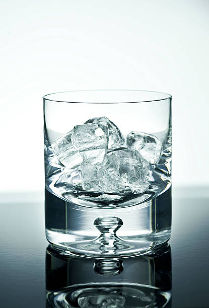Whisky Tumbler filled with ice stock photo