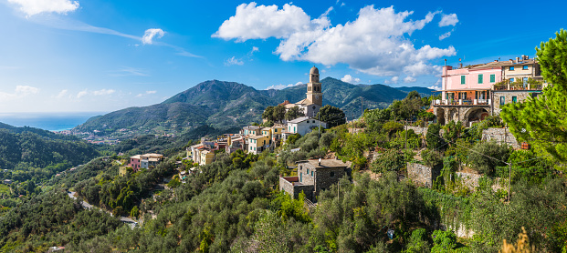 Panoramic vista across the villas and towers of Levanto set in the green forests of Cinque Terre overlooking the blue waters of the Mediterranean Ocean, Liguria, Italy.