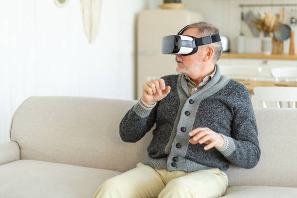 istock Excited mature senior man wearing using virtual reality metaverse VR glasses headset at home. Grandfather touching air during VR experience on virtual reality helmet. Simulation hi-tech videogame. 1739130688
