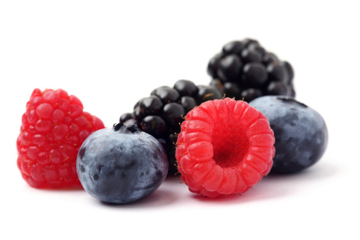 Various berries in a white plate. Blueberries, blackberries and raspberries are delicious diet berries.