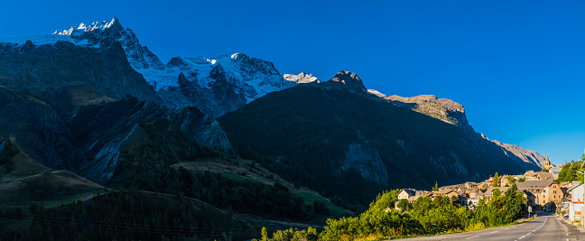 The snow capped peaks of the Alps overlooking the village of Villar-d'Arêne in Hautes-Alpes, France.