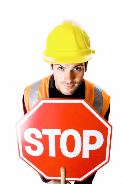 istock Portrait of  young  construction worker holding a stop sign 173914074
