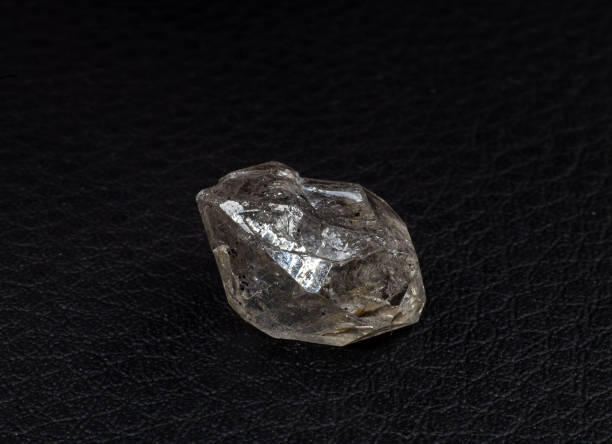 istock Real natural shaped double-terminated clear quartz Herkimer diamond crystal macro isolated on a black surface background 1739141856