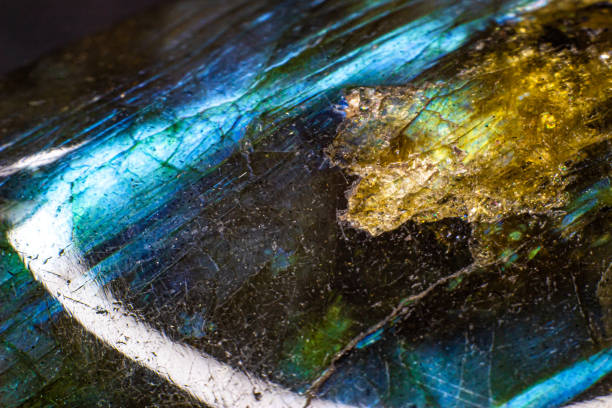 istock Shiny blue flash labradorite cabochon macro fully isolated on a black background. Blue stone with yellow spots 1739142438