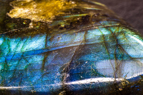 istock Shiny blue flash labradorite cabochon macro fully isolated on a black background. Blue stone with yellow spots 1739142440