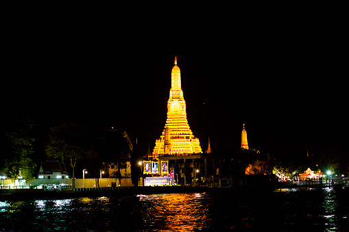 Panorama with Illuminated Wat Arun at Chao Praya river in Bangkok