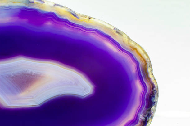 istock Purple and Blue agate slice crystal , banded chalcedony stone isolated on a white background surface with lots of detail. Abstract purple crystal image with lots of copy space 1739143670