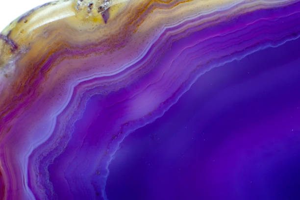 istock Purple and Blue agate slice crystal , banded chalcedony stone isolated on a white background surface with lots of detail. Abstract purple crystal image with lots of copy space 1739143681