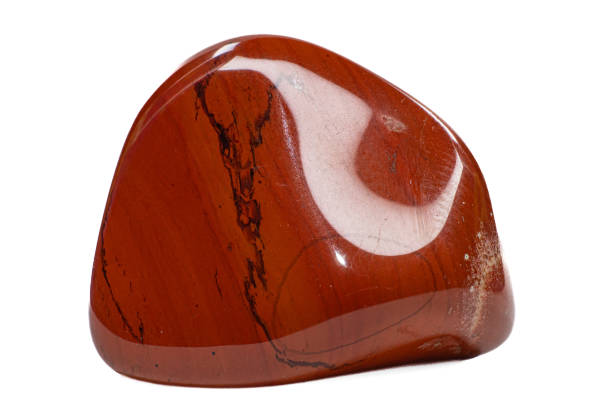 istock Macro brick red tumbled shiny jasper chalcedony crystal, shiny stone, isolated on a white surface background 1739144691