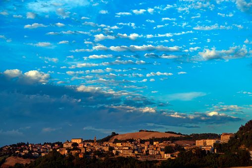 View of the village of Sassocorvaro on the hill against the sky with clouds