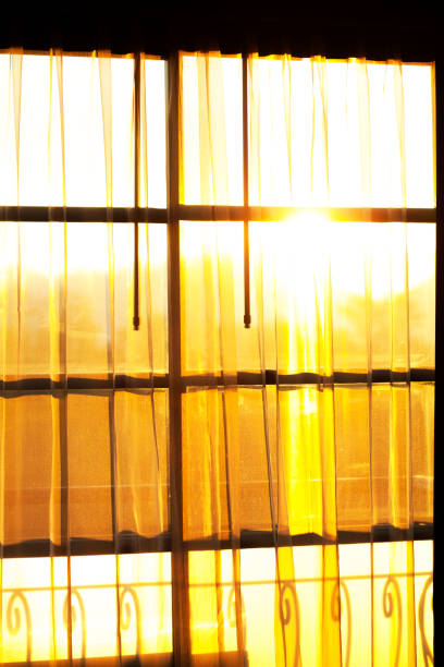 istock Sun and sunrise behind curtain and window 1739146211