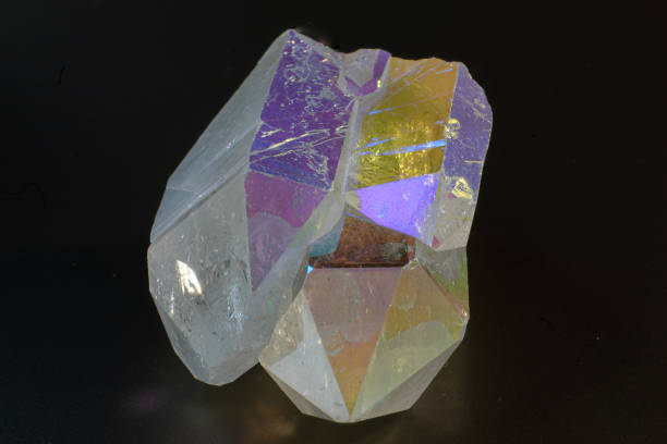 Colourful Angel Aura Quartz crystal point cluster on black surface