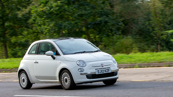 Milton Keynes,UK - Oct 16th 2023: 2012 white Fiat 500 car  driving on an English road.