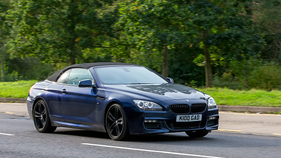 Milton Keynes,UK - Oct 16th 2023:2013 blue BMW 6 series 640D M Sport   driving on an English road.