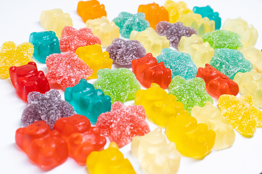 jelly star candies and gummy bears close up in isolated background
