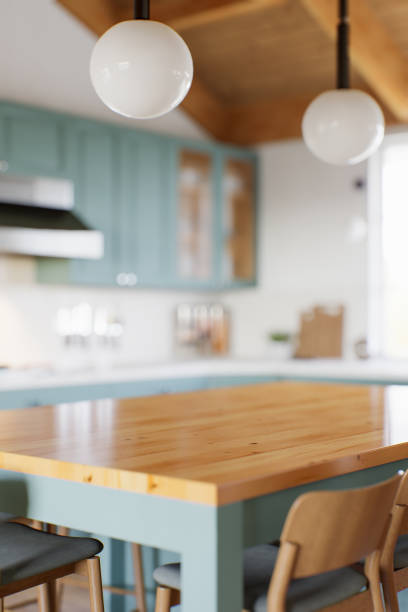 istock Green kitchen with wood countertops and accent island for product display. Empty kitchen countertop with blurred kitchen background with appliances and utensils. 3D rendering. 1739150420