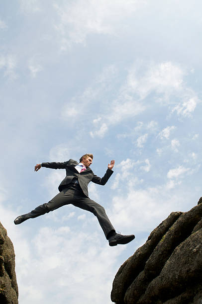 istock Courageous Businessman Jumping Over Valley 173915329