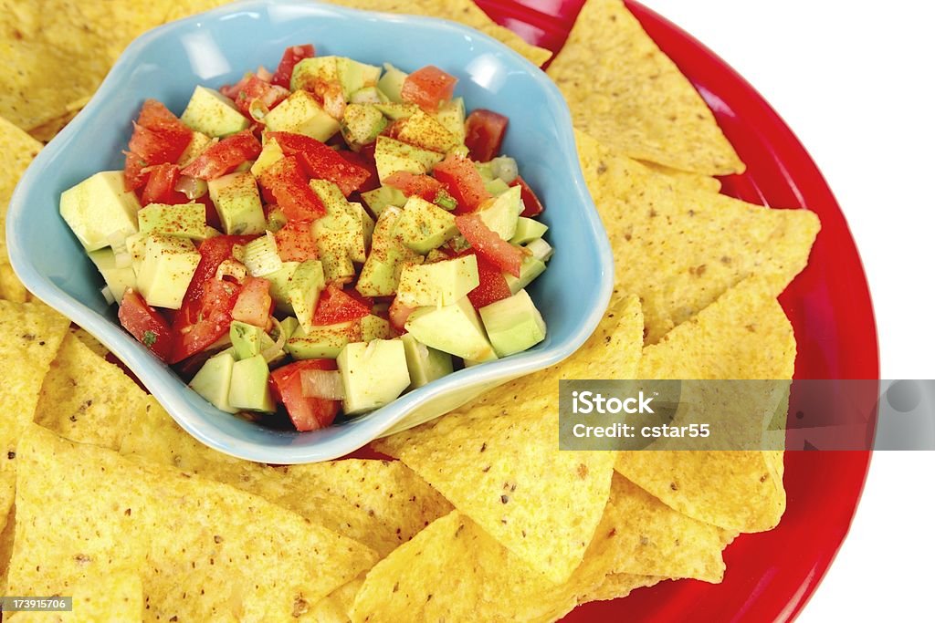 Avocado Salsa & Chips Dish of fresh avocado salsa with plate of chips.For more food images click below. Chopped Food Stock Photo