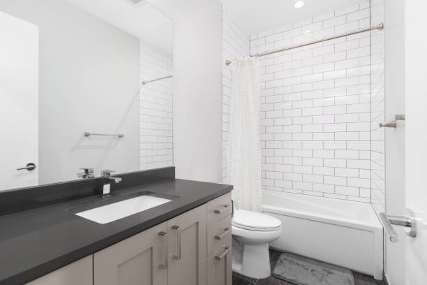 istock A bathroom with a brown cabinet and white subway tile shower. 1739158045