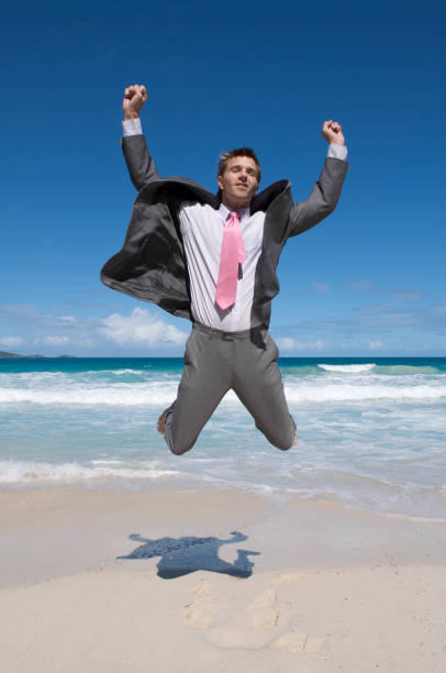 istock Businessman Jumps in the Sky on Beach 173916055