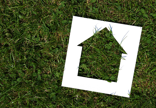 Green Housing - Cutout of a house on a grass background