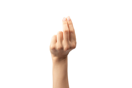 Hand of a woman holds some tiny or thin object, isolated on a white background.