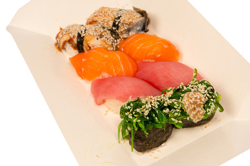 Sushi with salmon, eel, tuna, hiyashi wakame, sesame isolated on a white background.