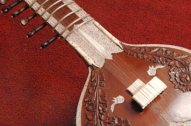 Close-up of sitar on red carpet