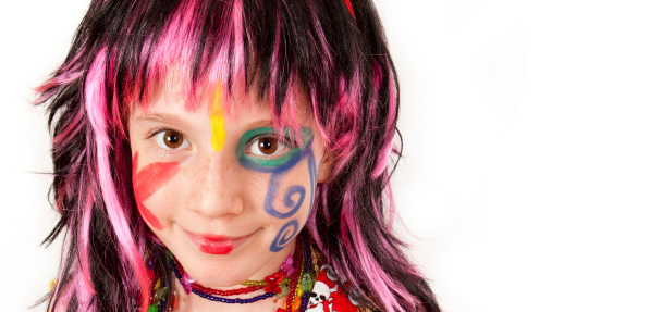 Cute girl with face paint and colorful wig.