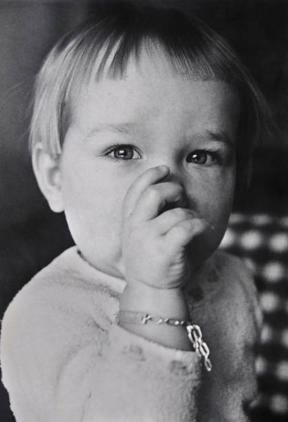 One year old boy, photographed in 1969. Black and White. Old photograph. Film grain to be seen.