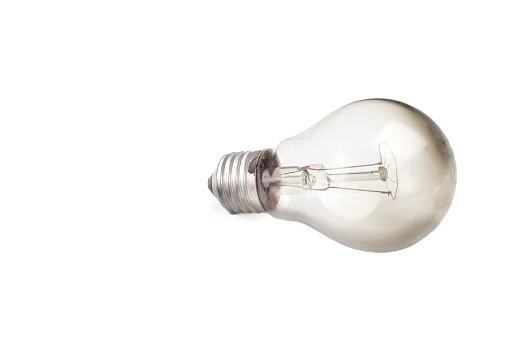 Close up view of burnt light bulb isolated on white background.