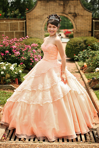 Beautiful Quinceanera Young teen wearing a quinceanera dress on her 15th birthday. quinceanera stock pictures, royalty-free photos & images