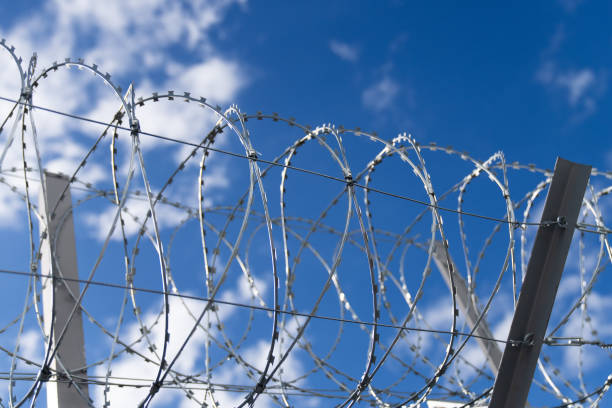 istock Fence with barbed wire. Barbed wire security fence. 1739182196