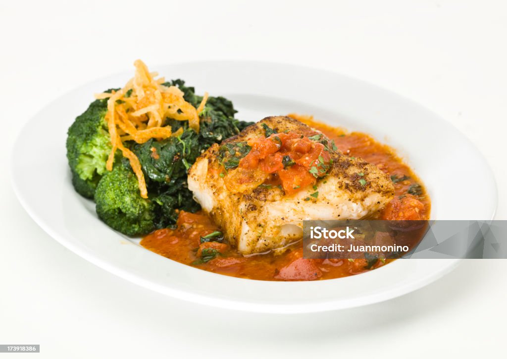 Sea Bass Pomodoro "Charbroiled sea bass brushed with olive oil, topped with a flavorful pomodoro sauce  (this picture has been shot with a super high definition Hasselblad HD3 II 31 megapixels camera)" Fish Stock Photo