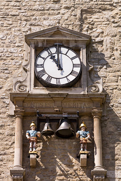 The Carfax Tower, at the heart of the town centre, Oxford, England is all that is left of the 13th Century St Martins Church. The facade shown here with the church clock is adorned by two mechanical Roman soldier 'quarter boys', who strike the bells at every 'quarter' of the hour. Fortis est veritas translates from latin to English as ‘Strong is the Truth’.