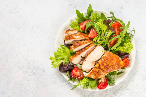 istock Grilled chicken with fresh salad at table. 1739191157