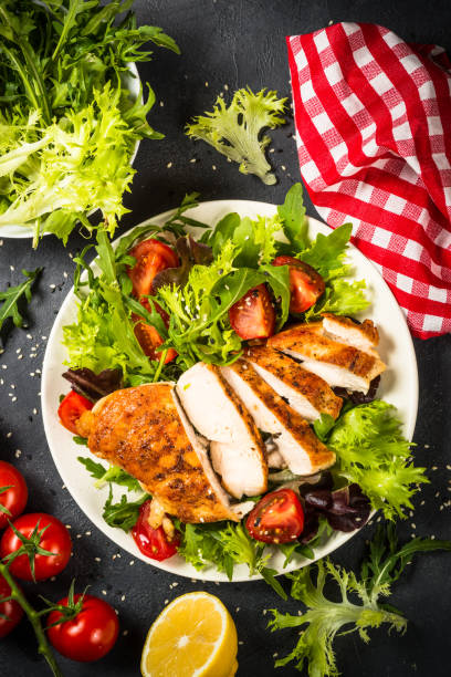 istock Grilled chicken with fresh salad at black. 1739191159