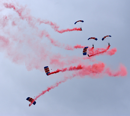 Ickwell, Bedfordshire, England - July 02, 2023: Parachute Display Team desending with red smoke.