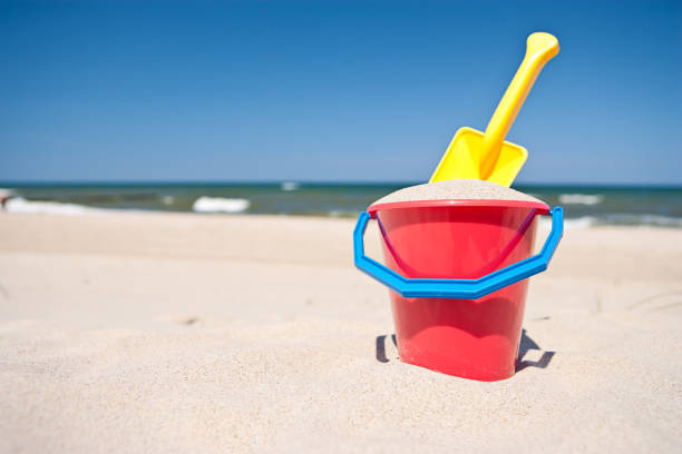 Colorful plastic toys on the beach