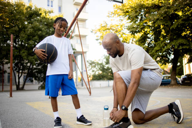 istock Man preparing for a basketball play with his son 1739196175