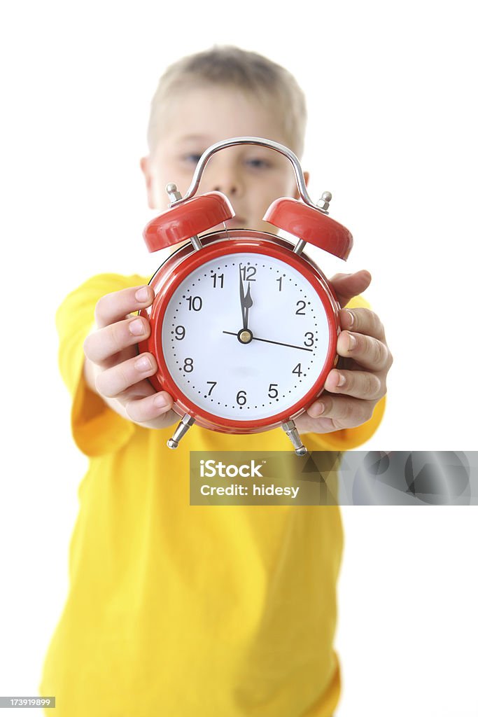 Boy Holding Alarm Clock Boy with alarm clock on white background Alarm Clock Stock Photo