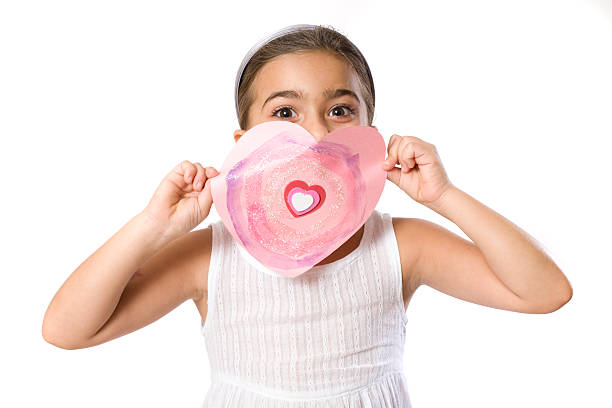 Little girl holding a Valentine stock photo