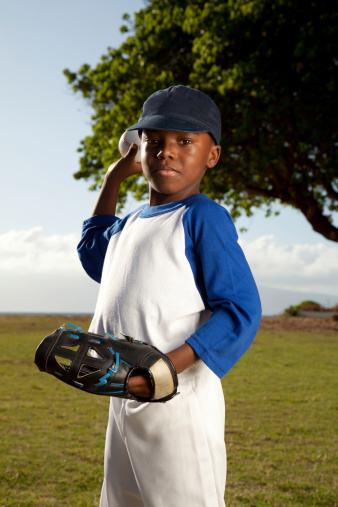 A little boy playing baseball.