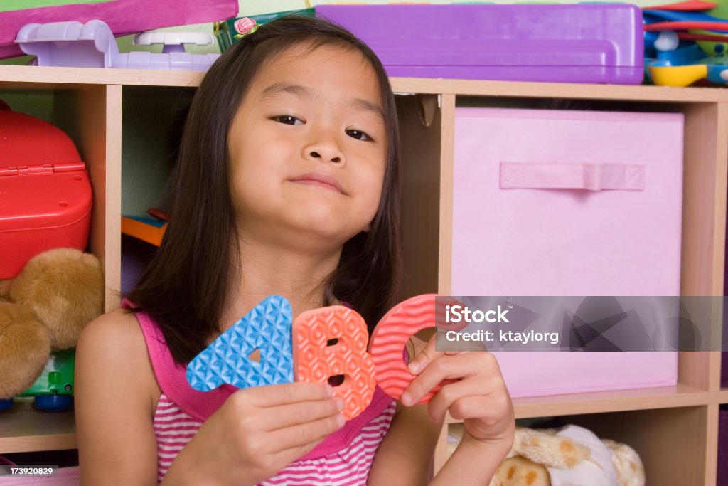 ABC "Little girl in her playroom holding letters A, B and C (shallow dof)" Learning Stock Photo