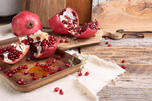 istock Fresh, ripe pomegranate on a wooden background. 1739208469