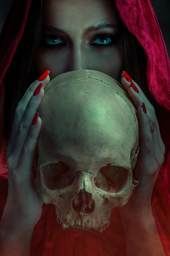 Witch holding human skull