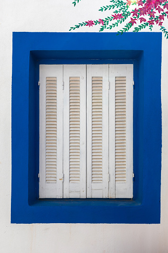 Blue window with mural in Greece